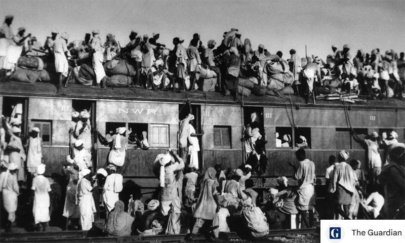 Displaced refugees crowded on top of a train during the migration across the border in Partition 1947
